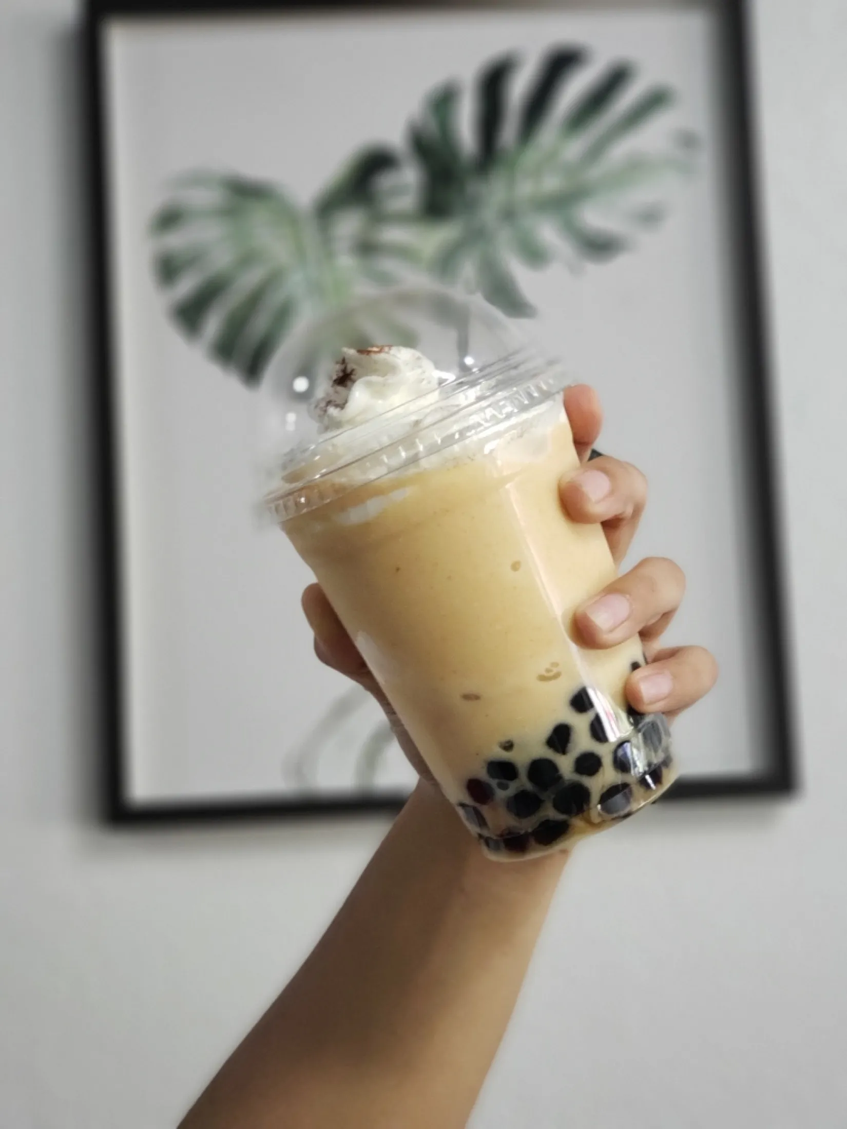 A blended boba with whipped cream