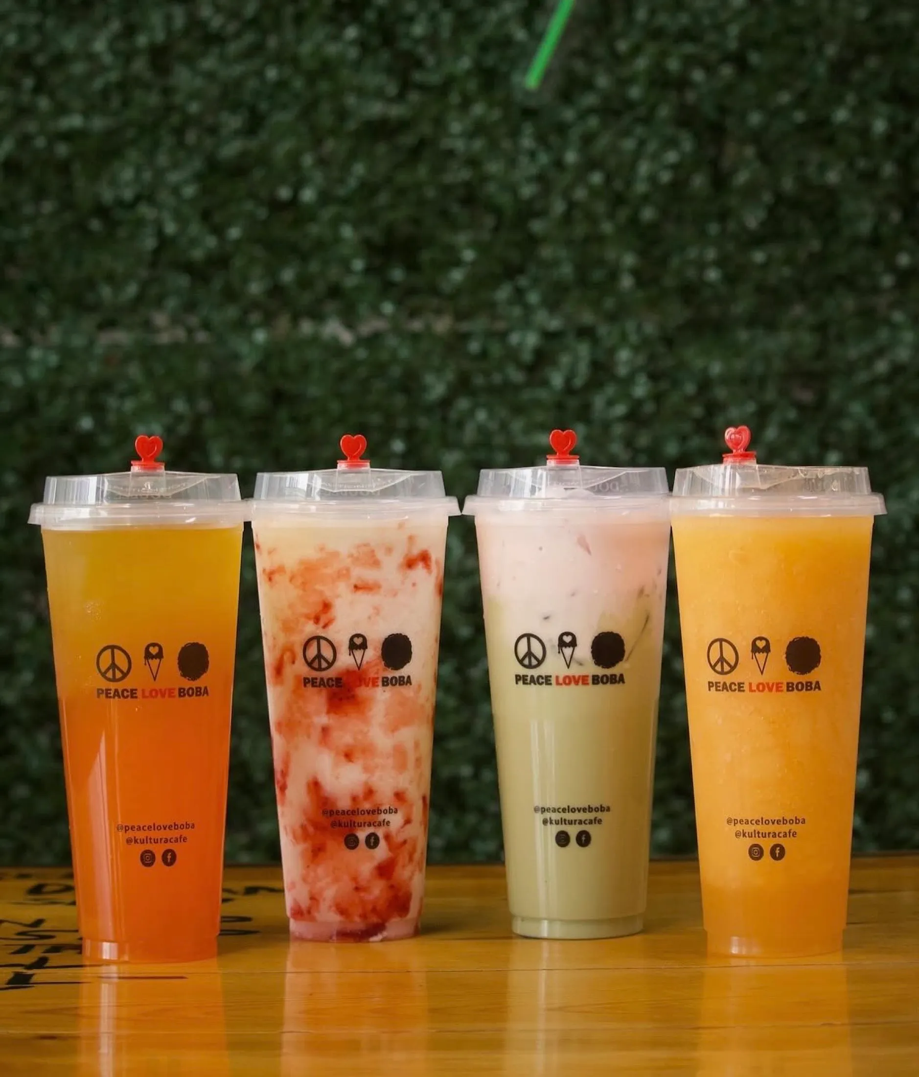 Row of branded PLB boba cups