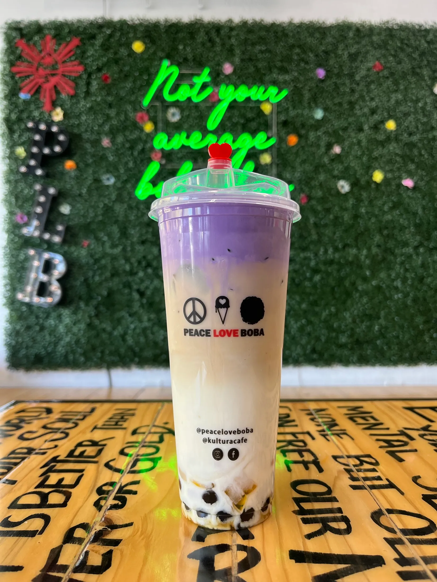A taro boba drink on the graffiti table