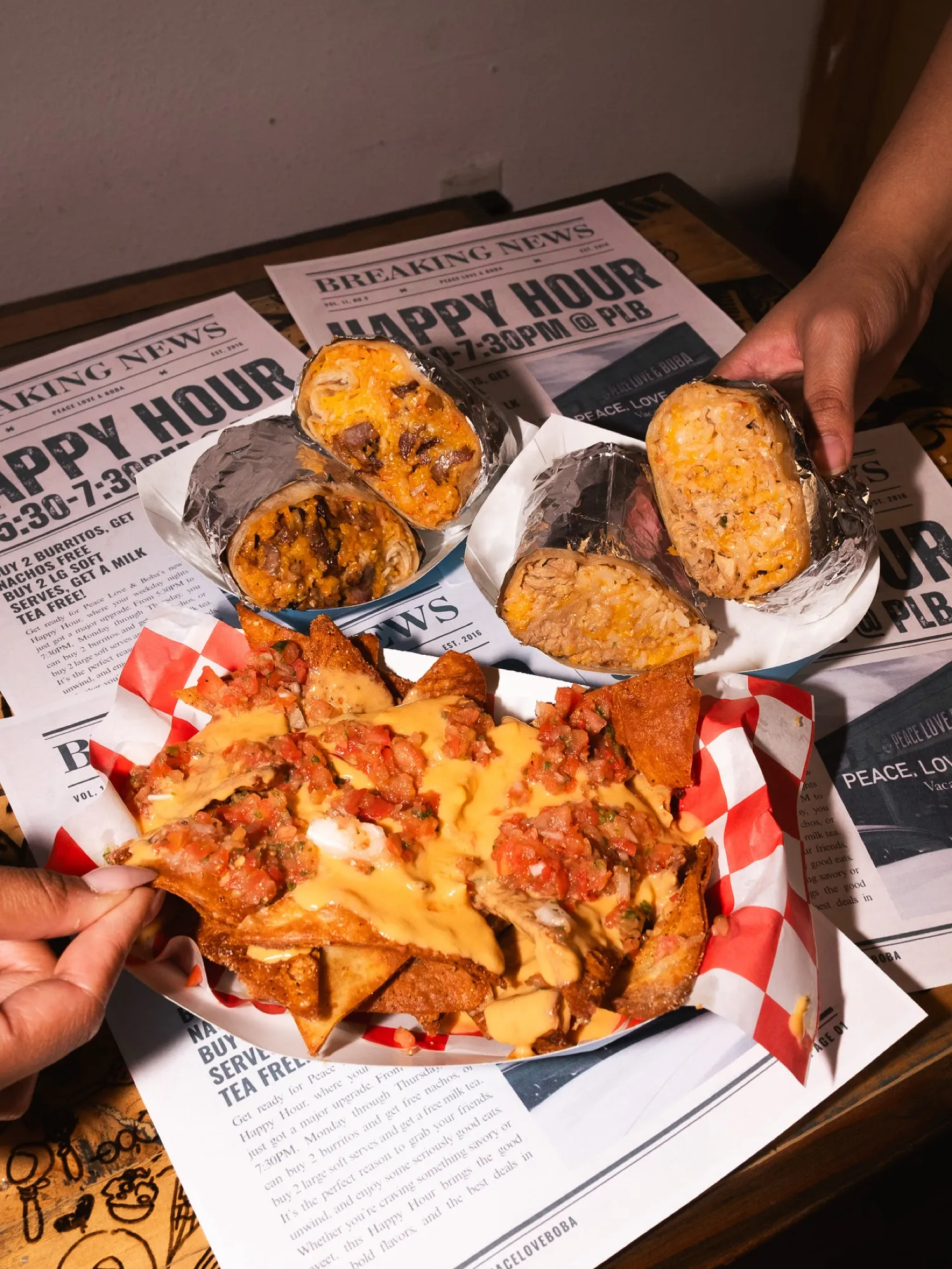 A happy-hour spread of burritos and nachos