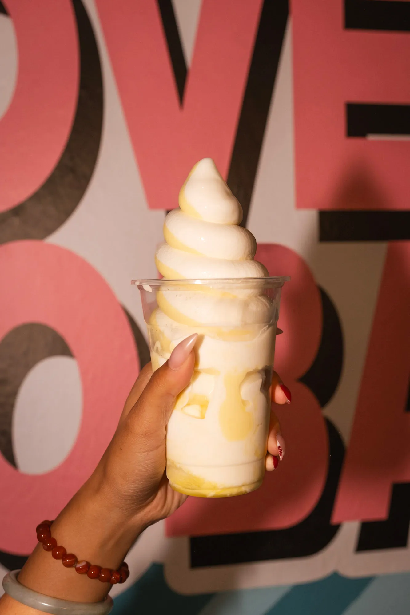 Pineapple soft serve in front of the mural