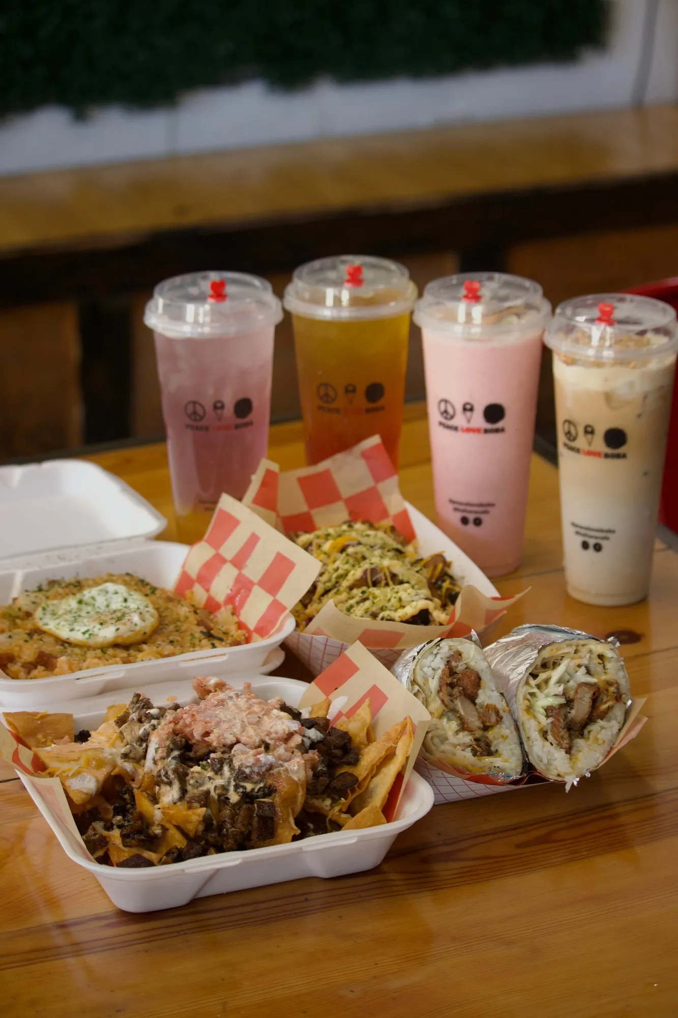 A spread of Peace Love & Boba drinks and food