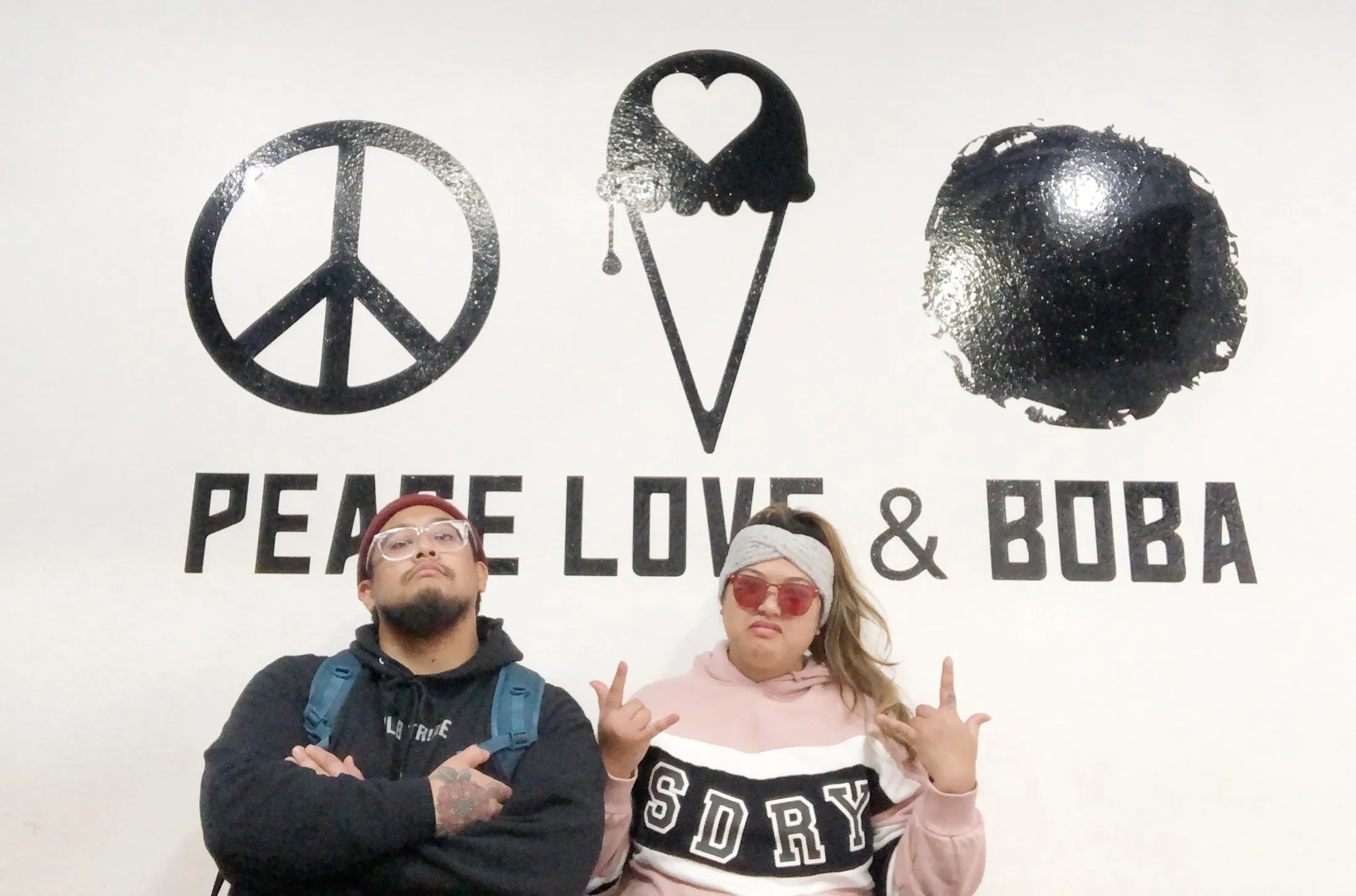 The crew at the peace-love-boba wall