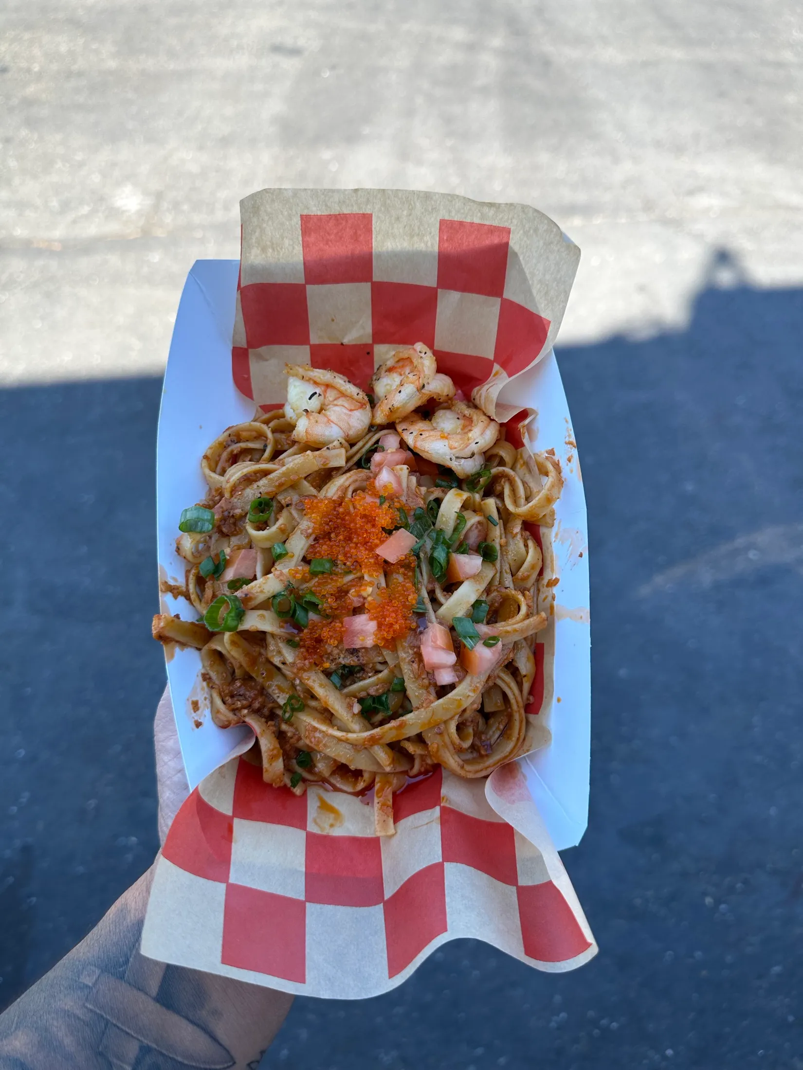 Shrimp pancit in a checkered tray