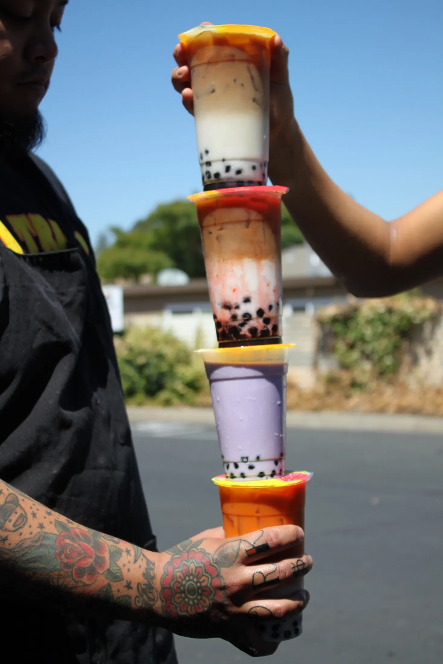 A tower of stacked boba drinks